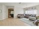 Open living room featuring tile floors, large windows, chandelier, and neutral paint at 34447 Windknob Ct, Wesley Chapel, FL 33545