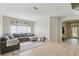 Open living room featuring tile floors, large windows, chandelier, and neutral paint at 34447 Windknob Ct, Wesley Chapel, FL 33545