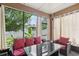 Relaxing sunroom with comfortable seating, bright windows, and backyard views at 34447 Windknob Ct, Wesley Chapel, FL 33545