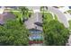 Aerial view of home featuring a large pool, screened-in patio, and mature landscaping at 4047 Eagle Cove West Dr, Palm Harbor, FL 34685