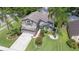 Beautiful home with lush landscaping, a long driveway, and mature palm trees at 4047 Eagle Cove West Dr, Palm Harbor, FL 34685