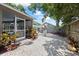 Landscaped backyard featuring a gravel area with outdoor seating and a screened-in porch at 4047 Eagle Cove West Dr, Palm Harbor, FL 34685