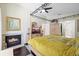 Main bedroom with fireplace, dark wood floors, and en-suite bathroom at 4047 Eagle Cove West Dr, Palm Harbor, FL 34685