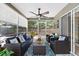 Screened patio with comfortable seating and a ceiling fan at 4047 Eagle Cove West Dr, Palm Harbor, FL 34685