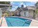Backyard with a screened-in pool and patio seating at 4047 Eagle Cove West Dr, Palm Harbor, FL 34685