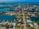 Aerial view of waterfront homes and canals, near city, offering luxurious living with boat docks and scenic surroundings at 431 Windward Psge, Clearwater Beach, FL 33767