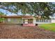 The backyard features mature trees that offer plenty of shade and a well-manicured lawn at 431 Windward Psge, Clearwater Beach, FL 33767