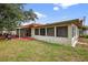 Backyard showcasing a red-tiled patio, and an enclosed sunroom on home's exterior at 431 Windward Psge, Clearwater Beach, FL 33767