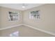 Cozy bedroom with natural light, two windows, neutral walls, and modern flooring at 431 Windward Psge, Clearwater Beach, FL 33767