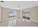 Bright bedroom with large windows, patio access, and a ceiling fan offers a serene and inviting space at 431 Windward Psge, Clearwater Beach, FL 33767