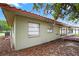 Home exterior featuring an attached patio, mulch landscaping, and neutral paint at 431 Windward Psge, Clearwater Beach, FL 33767