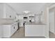 Stylish, all white kitchen with stainless steel appliances and an island for added counter space at 431 Windward Psge, Clearwater Beach, FL 33767