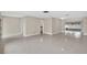 Open living space with a neutral color palette, terrazzo flooring, and bright lighting at 431 Windward Psge, Clearwater Beach, FL 33767