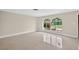 Bright living room with neutral walls, large arched windows, and terrazzo flooring at 431 Windward Psge, Clearwater Beach, FL 33767