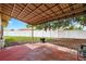 Covered patio with view of fenced-in yard and shade trees at 431 Windward Psge, Clearwater Beach, FL 33767