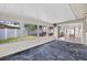 Enclosed sun room with tile floor, large windows overlooking yard and access to interior at 431 Windward Psge, Clearwater Beach, FL 33767