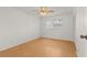A bright bedroom features wood floors, ceiling fan, and a window for natural light at 4500 E Bay Dr # 106, Clearwater, FL 33764