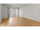 Bright, empty bedroom with wood floors and sliding glass door to porch at 4500 E Bay Dr # 106, Clearwater, FL 33764