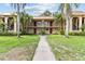 Inviting two-story condo complex with lush landscaping and a well-maintained walkway leading to the entrance at 4500 E Bay Dr # 106, Clearwater, FL 33764