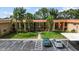 Condo exterior featuring a well-maintained lawn, palm trees, and convenient covered parking at 4500 E Bay Dr # 106, Clearwater, FL 33764