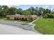 Aerial view showcases the condo complex with a swimming pool and well-manicured lawns at 4500 E Bay Dr # 106, Clearwater, FL 33764