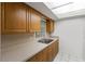 Bright kitchen featuring wooden cabinets and a stainless steel double sink at 4500 E Bay Dr # 106, Clearwater, FL 33764