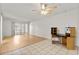 Bright living room with tile and wood floors, ceiling fan, and sliding glass doors at 4500 E Bay Dr # 106, Clearwater, FL 33764