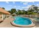 Inviting community pool area with lounge chairs and lush landscaping provides a relaxing outdoor space at 4500 E Bay Dr # 106, Clearwater, FL 33764
