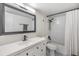 Bright bathroom with white vanity, black hardware, and a shower-tub combo at 4513 S Oak Dr # Q21, Tampa, FL 33611
