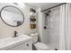 Bathroom featuring a round mirror, updated shower and plenty of storage at 4513 S Oak Dr # Q21, Tampa, FL 33611