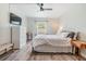Bright bedroom featuring a queen-size bed, wood flooring and a large window at 4513 S Oak Dr # Q21, Tampa, FL 33611