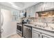 Modern kitchen featuring stainless appliances, granite countertops, and ample cabinet space at 4513 S Oak Dr # Q21, Tampa, FL 33611
