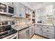 The kitchen boasts granite countertops, stainless steel appliances and elegant white cabinets at 4513 S Oak Dr # Q21, Tampa, FL 33611
