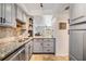 This kitchen features granite countertops, stainless appliances, and views of the living room at 4513 S Oak Dr # Q21, Tampa, FL 33611