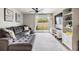Relax in the living room with plush gray sectional sofa and sliding glass doors to the backyard at 4513 S Oak Dr # Q21, Tampa, FL 33611