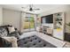 Cozy living room with sliding glass doors, built in shelving, and large television at 4513 S Oak Dr # Q21, Tampa, FL 33611