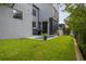 A modern home's backyard features a small pool, nice green grass and access to an outdoor deck at 4806 W Euclid Ave, Tampa, FL 33629