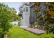 Modern home showcasing beautiful backyard with a pool, spa, lush lawn, and patio area at 4806 W Euclid Ave, Tampa, FL 33629