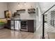 Bar area with custom shelving, a wine fridge, beer tap, and a view of a staircase at 4806 W Euclid Ave, Tampa, FL 33629