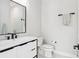 Modern bathroom with sleek white vanity, black hardware, and glass shower door at 4806 W Euclid Ave, Tampa, FL 33629