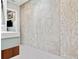 Contemporary bathroom with a concrete accent wall and a glimpse into an adjacent room at 4806 W Euclid Ave, Tampa, FL 33629