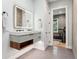 Modern bathroom with a floating vanity, illuminated mirror, and a view of the exercise room at 4806 W Euclid Ave, Tampa, FL 33629
