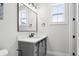 Bathroom featuring gray vanity with marble countertop and decorative tile floor at 4806 W Euclid Ave, Tampa, FL 33629
