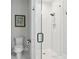 Modern bathroom with glass-enclosed shower, white tile, and sleek fixtures at 4806 W Euclid Ave, Tampa, FL 33629