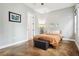 Bedroom features wood-look floors, modern decor, and plenty of natural light from the windows at 4806 W Euclid Ave, Tampa, FL 33629