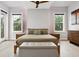 Serene bedroom with textured accent wall, ensuite bath, and views of the neighborhood at 4806 W Euclid Ave, Tampa, FL 33629