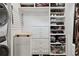Organized closet with built-in shelving, drawers, and a convenient laundry area at 4806 W Euclid Ave, Tampa, FL 33629