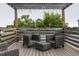 A cozy deck area under a pergola with comfortable seating for relaxation and outdoor enjoyment at 4806 W Euclid Ave, Tampa, FL 33629