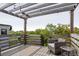 Outdoor deck space under a pergola with chairs and views of the surrounding trees at 4806 W Euclid Ave, Tampa, FL 33629