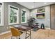 Functional room with a desk, exercise equipment, and large windows offering green views at 4806 W Euclid Ave, Tampa, FL 33629